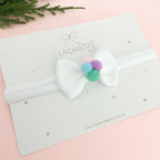 Laço Bia com Pompons P na Faixinha